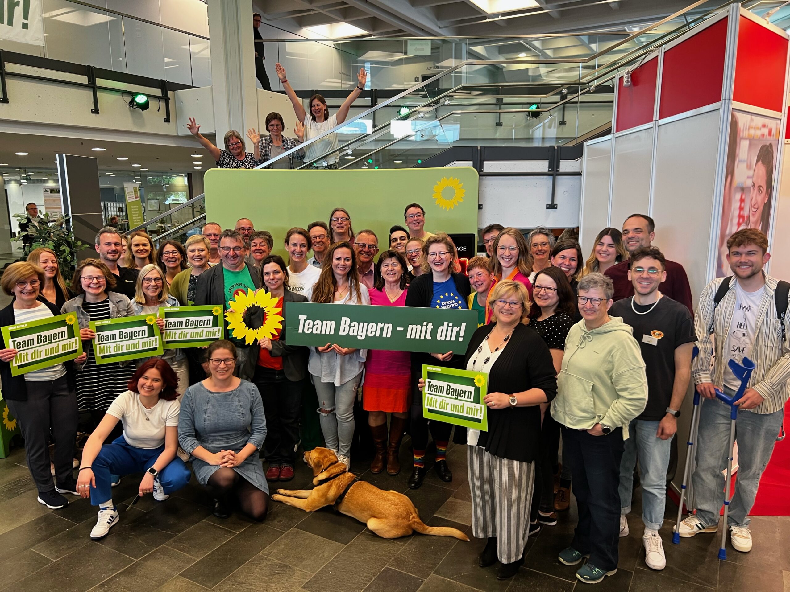 Dutzende schwäbische Grüne mit Haltern: Sonnenblumen-Logo und Schriftzug "Team Bayern - mit dir"